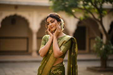 Indian girl with her hands on her face. the girl is in saree. kryskair name at the bottom